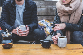 Two person in front of coffee table